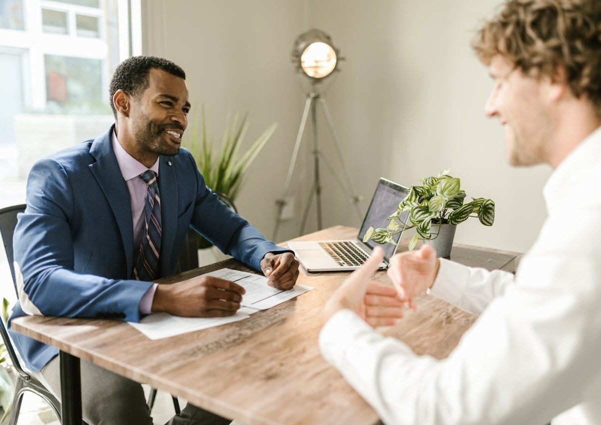 Men Sitting at Table Smiling